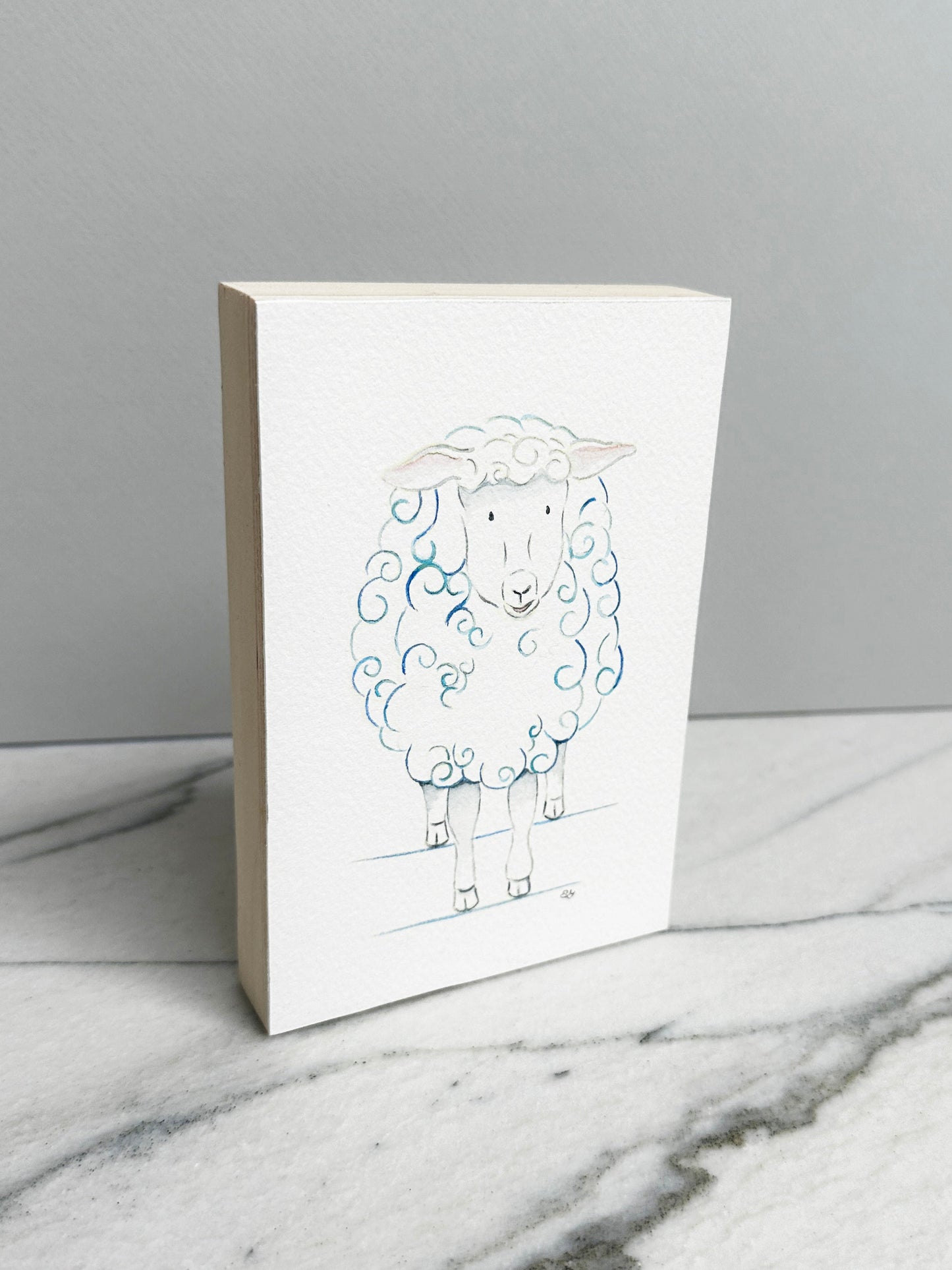 Bella the Sheep, an original watercolor painting of a sheep with soft blue curls, mounted on a cradled wood panel, side view