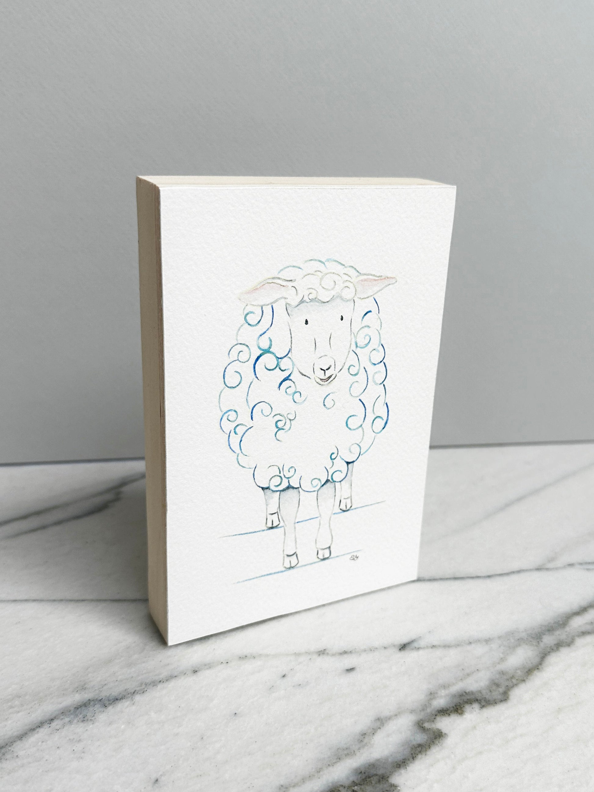 Bella the Sheep, an original watercolor painting of a sheep with soft blue curls, mounted on a cradled wood panel, side view
