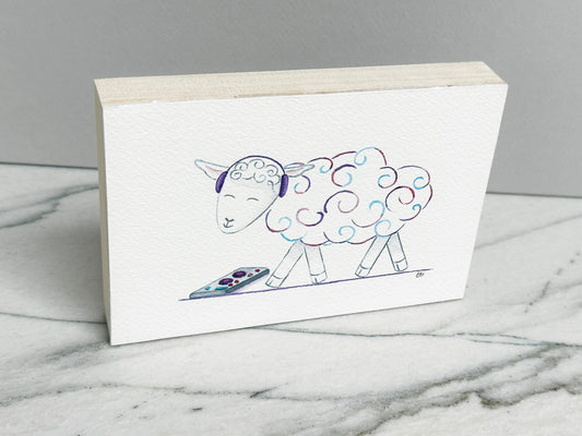 DJ Curlz the Sheep, an original watercolor painting of a sheep in headphones with pink and purple curls, mounted on a cradled wood panel, side view